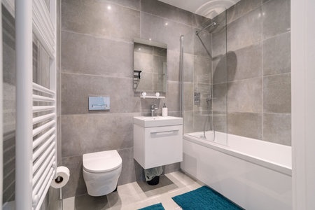 Modern bathroom design featuring sleek fixtures and calming color tones in an urban apartment...