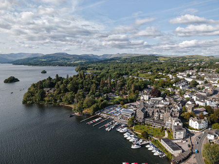 Scenic view of a lakeside village surrounded by mountains in the daytimeの写真素材