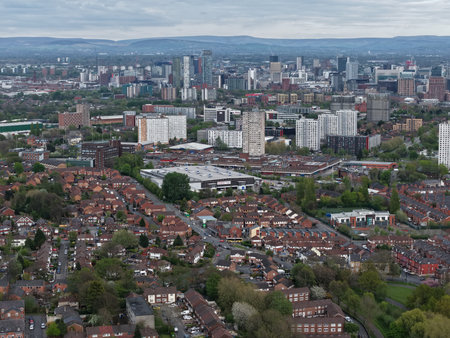 View of urban Manchester showcasing residential areas and skyline in daylight with mottled cloudsの写真素材