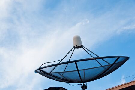 Black sattelite dish and blue sky.の写真素材