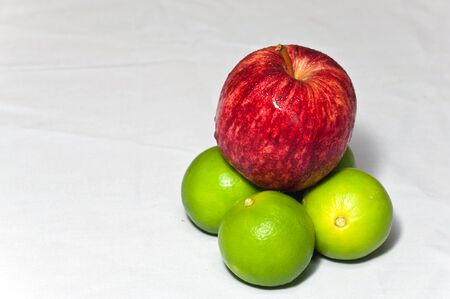 Apple and lemon on desk.の写真素材