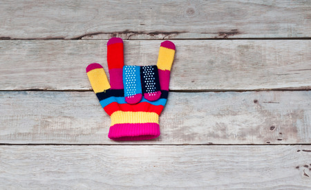Colorful glove on wooden background.の写真素材