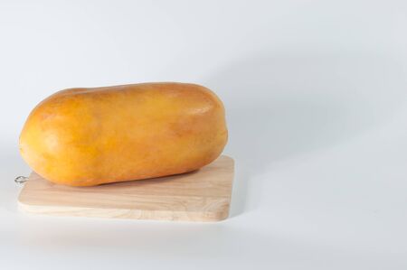 Papaya fruit on wood and white background copy space.(Soft focus.)の写真素材