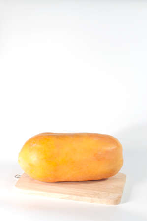 Papaya fruit on wood and white background copy space.(Soft focus.)の写真素材
