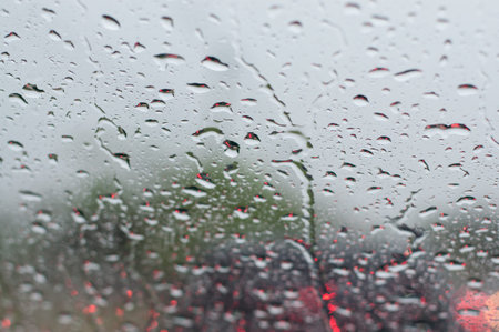 Water drop on windshield of car in rainy season,traffic  jam.(Soft focus.)