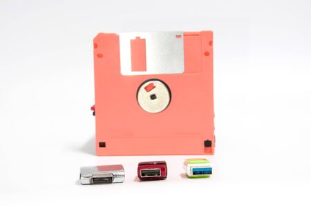 Old floppy disk and flash drive put on white background,soft focus.の写真素材