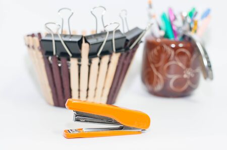 Orange staple and other equipment on white background,selective focus.の写真素材