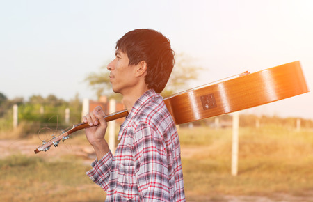 Man playing guitar in outdoor,soft focus.の写真素材