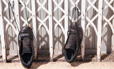 Old men's shoe hanging on outside,selective focus.の写真素材