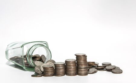 Saving money coin in bottle concept on white background,selective focus.の写真素材