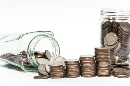Saving money coin in bottle concept on white background,selective focus.の写真素材