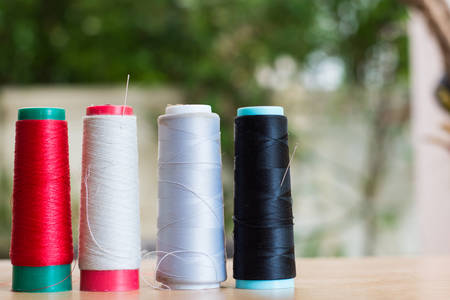 Old thread on wood table,soft focus.の写真素材