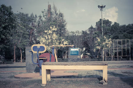 Old yellow wooden chair in park,soft focus.の写真素材