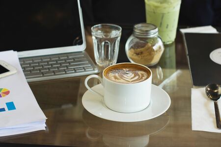 Coffee cup on wood table at work office,selective focus.の写真素材