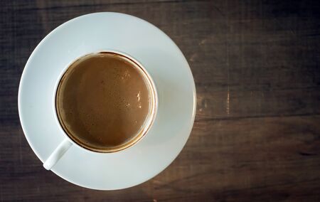 Coffee cup on wood table at work office,selective focus.の写真素材