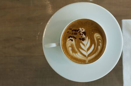 Coffee cup on wood table at work office,selective focus.の写真素材