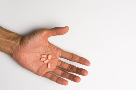Medicine or pill in hand on white background,soft focus.の写真素材
