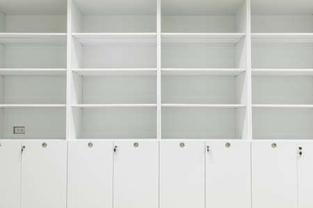 White cabinet and shelves in room.の写真素材