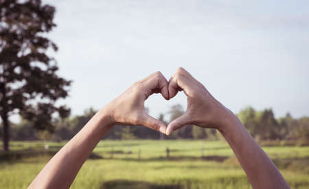 Hand of female in shape of heart for love,soft focus.の写真素材