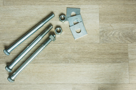Metal screw and nut on floor.の写真素材