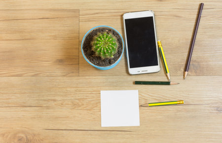 Paper note with smart phone and other on table,top view.の写真素材