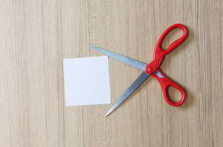 Scissors with other on wooden table.