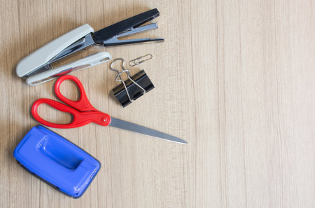 Scissors with other on wooden table.の写真素材