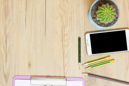 Paper note with smart phone and other on table,top view.の写真素材