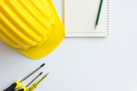 Yellow safety helmet with other on white table,copy space.の写真素材