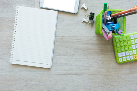 Flat lay of notebook with other on work desk.