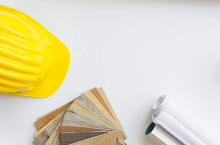 Yellow safety helmet with other on white table,copy space.の写真素材