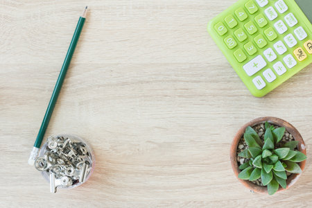 Flat lay of green calculator with other on work desk.の写真素材