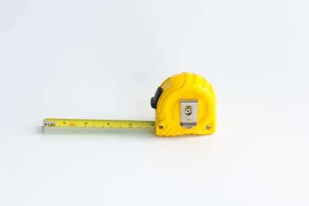 Yellow measuring tape on white background.
