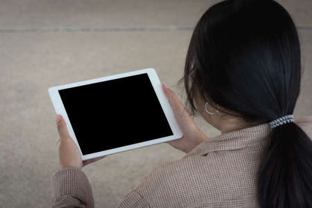 Woman worker using tablet computer at outdoor,soft focus.の写真素材