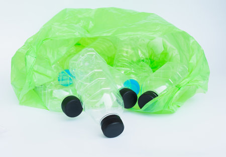 Plastic bottle in green bag on white background,save world concept.の写真素材
