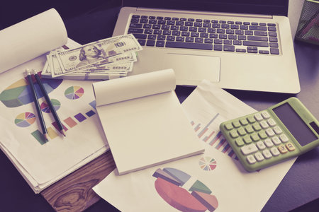 Paper note with other on work table,money,finance,business concep soft focus.