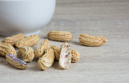 Group of peanut on wooden table background,copy space.