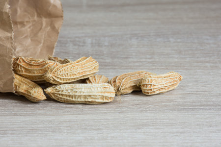 Group of peanut on wooden table background,copy space.