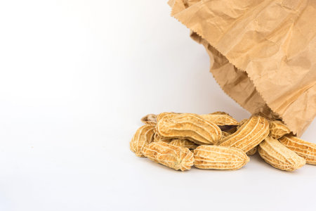 Group of peanut with paper bag on white background,copy space.