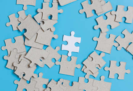 Jigsaw puzzle on blue background,contrast concept.の写真素材