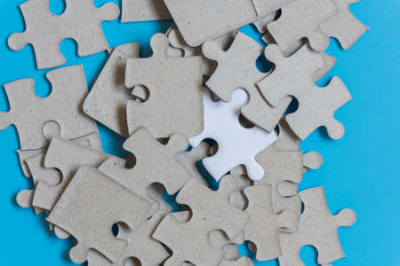 Jigsaw puzzle on blue background,contrast concept.の写真素材