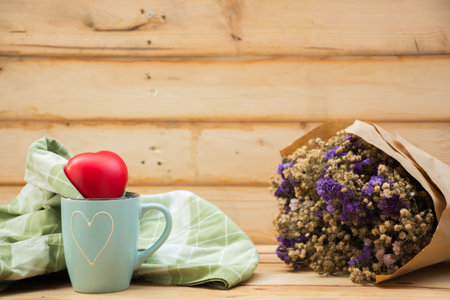 Mug with heart shape on wooden background.selective focus.の写真素材