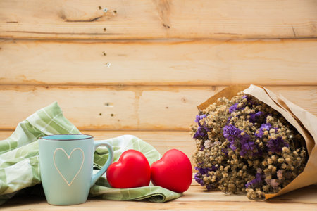 Mug with heart shape on wooden background.selective focus.の写真素材