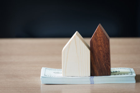 Saving concept,money with small wooden home on work table,selective focus.の写真素材