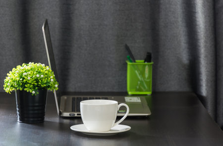 White coffee cup on work desk,soft focus.の写真素材