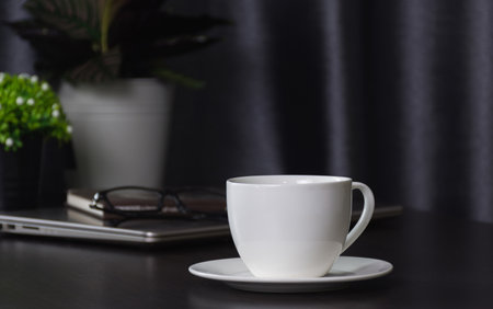 Coffee cup on work table,soft focus.の写真素材