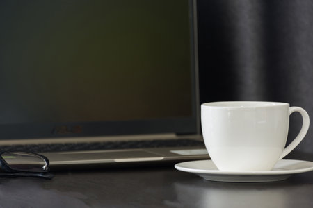 Coffee cup on work table,soft focus.の写真素材