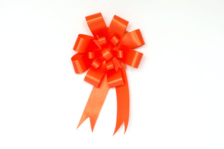 Orange bow ribbon on white background.