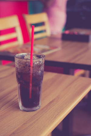 Coca Cola with ice on the wooden floorの写真素材