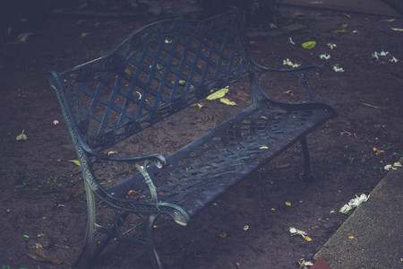 Empty bench in park autumn leaves,Lonely atmosphereSelective focusImage style vintageの写真素材